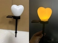 Solar powered heart-shaped garden stake light with warm yellow LED glow and black pole - Single Heart White