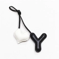 Close-up of handmade leather bag charm featuring a black Y letter and white heart detail - Black with Off-white Heart