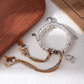 Detailed shot of silver bracelet with peace charms and fortune bell on wood - L506-2 Yellow Wealth God
