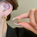 Detailed view of elegant gold-tone knotted hoop earrings on a model’s ear and hand - 29# Ear Buckle - Gold Multi-Layer Knot