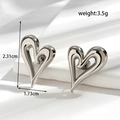 Polished silver heart-shaped titanium steel earrings with detailed product dimensions - Hollow Heart Stud Earrings / Silver
