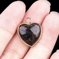 Heart-shaped pendant with a gold metal frame and a deep black natural stone inlay - Fireworks Stone Gold Edging