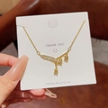 Golden lily of the valley necklace with rhinestone leaf pendant on white card - X562 Gold Lily of the Valley Leaf