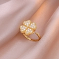 Adjustable gold clover ring featuring micro-pave white zircons on pink silk background - Golden Heart Ring / Gold