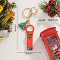 Detailed view of red Christmas wreath nail clipper keychain with a green tree charm - Christmas