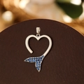 Detailed view of silver heart-shaped pendant with blue crystals and fishtail design - Silver Fishtail