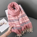Pink and beige striped knit scarf with tassels held by hand in a lifestyle setting - 70*180cm / Red