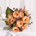 Faux orange-pink peony silk bouquet with green leaves on white fabric background - Yellow