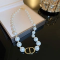 Elegant white pearl necklace featuring a gold CD logo pendant on a presentation box - 12# Necklace-Gold Oval (HN2476)