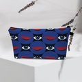 Detailed view of evil eye waterproof makeup bag on white pedestal with dried flowers - White Color Pupil