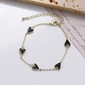 Detail of gold chain bracelet with five black heart charms and adjustable lobster clasp - Black Heart Enamel Bracelet (0428-4 Black)