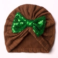 Detailed view of brown knitted baby turban hat with a large green sequin bow decoration - Coffee