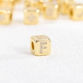 Macro shot of gold-plated copper cube bead with inlaid CZ letter F for necklaces - F (Single Pendant)