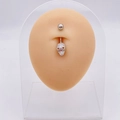 Silver skull navel ring with detailed textures on silicone body model display - Cool Skull