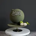 Detailed view of moss green frosted ball cake with silver Happy Birthday acrylic topper - Design No.9 / Silver