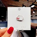 Detailed view of a cute pink and white enamel pig brooch badge on a paper display card - 27*Cute Pink Pig Pin