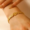 Golden bracelet with sunburst texture circular charms worn on a female wrist - Dot Sunburst Pattern (8960)