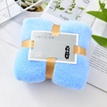 Light blue coral fleece face towel tied with gold ribbon in a stylish gift package - Sky Blue