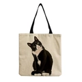 Detailed close-up of a black cat print on a natural linen tote bag with fabric texture - Black and White Cow Cat (hm1306)