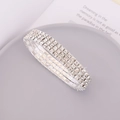 Close-up of a silver elastic bracelet featuring three rows of sparkling clear rhinestones - 3 Layers Style
