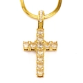 Macro detail of gold cross pendant with cubic zirconia on a sleek snake chain - Gold White