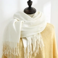 Creamy beige solid color cashmere-like scarf with fringe details on a mannequin - Pure White
