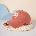 Close-up of MOM LIFE embroidery and heart detail on washed cotton baseball cap - Orange