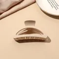 Close-up of a minimalist cream matte hair claw clip on elegant silk fabric background - Beige Matte-Half Moon B