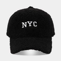 Detailed view of the fuzzy black Sherpa fabric and white NYC embroidery on the baseball cap - Adjustable / Black