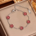 Bracelet en acier inoxydable argenté avec cinq breloques fleurs rouges serties - Acier Zirconium Rouge