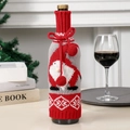 Christmas knitted wine bottle cover featuring Santa gnome design and red pom pom ties - Red and Grey Rudolf Style