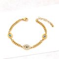 Gold Cuban link bracelet featuring three blue evil eye pendants with sparkling white zircons - Bracelet