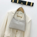 Champagne silver shoulder bag with geometric embossed texture on a wooden hanger - Silver