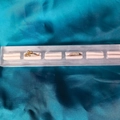 Golden clover and sparkling diamond rings displayed on a clear acrylic jewelry stand - 6 Slots Brushed Base White Velvet 22*3.5CM