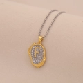 Detail of golden letter F pendant with crystals on a delicate silver bead chain - Letter F