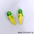 Detail view of yellow glass corn charms with green loops for DIY jewelry, 3.1x1.2cm size - Corn