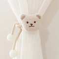Beige plush bear curtain tieback with woven rope and pompom detail on white curtain - Light Corn Rope Beige Bear