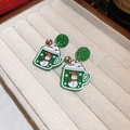 Macro shot of green glitter cup earrings with snowman and candy cane festive details - Christmas Green Snowflake Cup Style