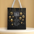 Detail view of black Christmas tote bag with gold festive print on a circular pedestal - Style 58