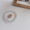 Pink shell-shaped hair claw clip with gold lines in a decorative glass dish - Pink