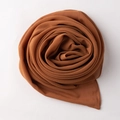 Detailed top view of a brown chiffon hijab folded in a neat circular shape showing texture - 90*90cm / Honey Orange Brown