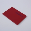 Red PU leather passport cover with blue text shown from a side perspective view - Red