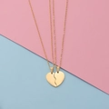 Detail of split heart puzzle pendants in polished gold finish with cross chains - Gold Set