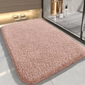Modern pink plush bathroom rug with thick absorbent pile on grey tiled floor - Pink
