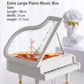 Close-up of white piano music box with golden interior and a ballet dancer figurine - XL Piano with Dancing Girl Music Box