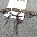 Macro detail of Y2K vintage leather belt with bronze studs and metal ring connectors - Six Flower Lace-up Style / Dark Coffee