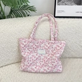 Quilted floral tote bag in pink cotton with Seeakka Studio label on a white sofa - Flower White Rabbit