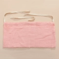 Detail of pink cotton gauze baby organizer showing dual pockets and white tie straps - Pink