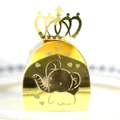Close-up of golden elephant hollow candy box with heart patterns and crown handle - Reflective Gold