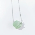Detailed view of large raw green crystal pendant with silver delicate chain necklace - Fluorite